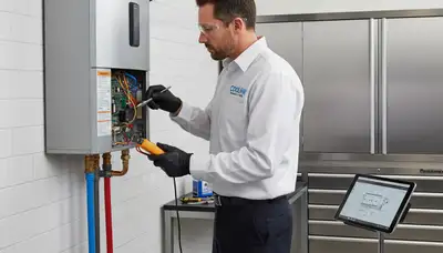 Technician performing water heater repair in Kansas City MO home by Five Star Cooling